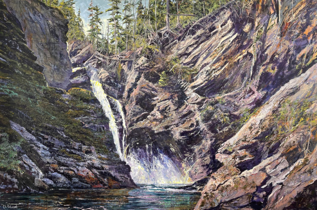 Waterfall flows between rocky cliffs into a pool, trees atop cliffs, highlighting natural beauty.