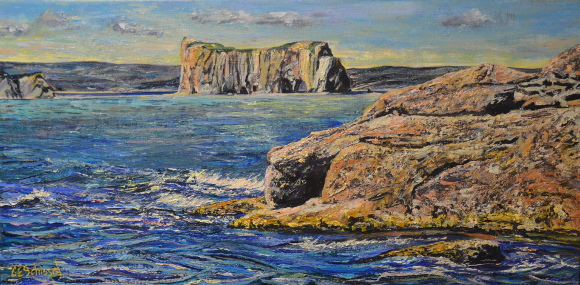 Scenic coastal landscape with rugged cliffs, rocks, vibrant blue water, and partly cloudy sky.